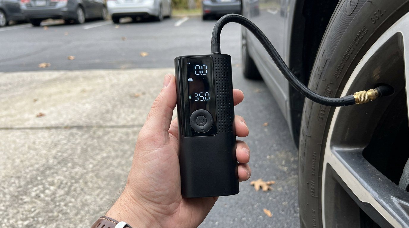 Airmoto portable tire inflator in hand close-up